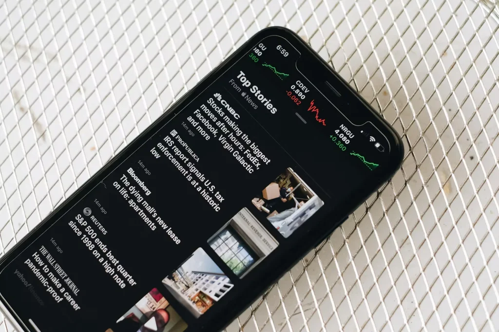 Smartphone displaying financial news and stock market updates