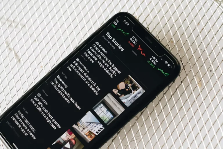 Smartphone displaying financial news and stock market updates