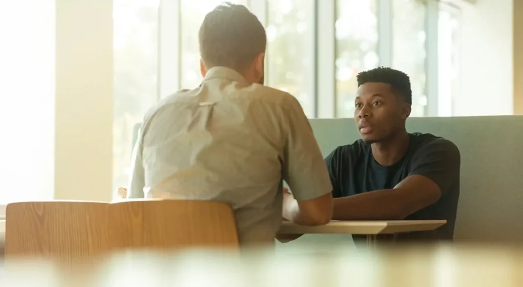 Therapist listening to a client during a private therapy conversation