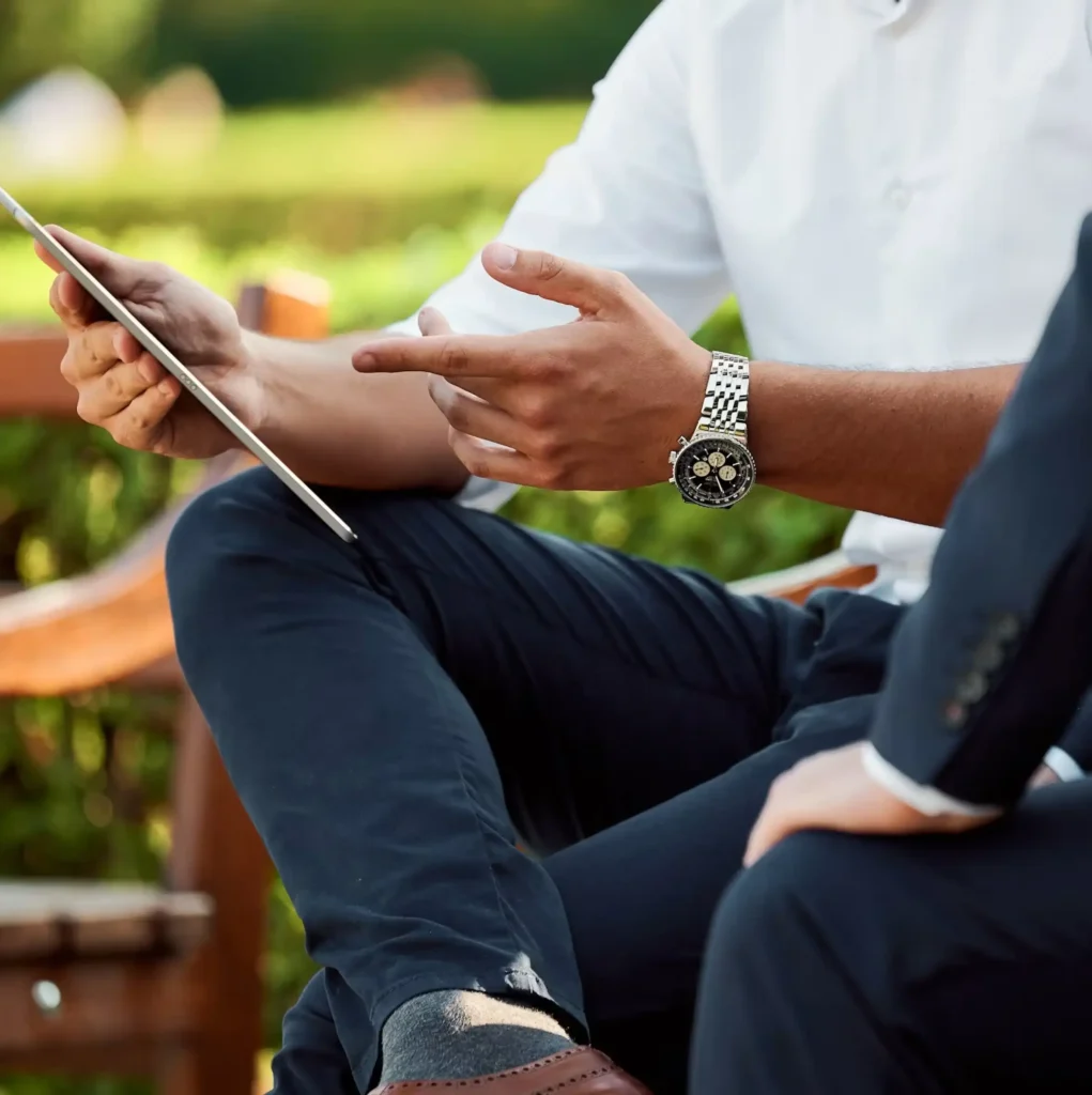 Therapist and client reviewing information on a tablet during an outdoor consultation