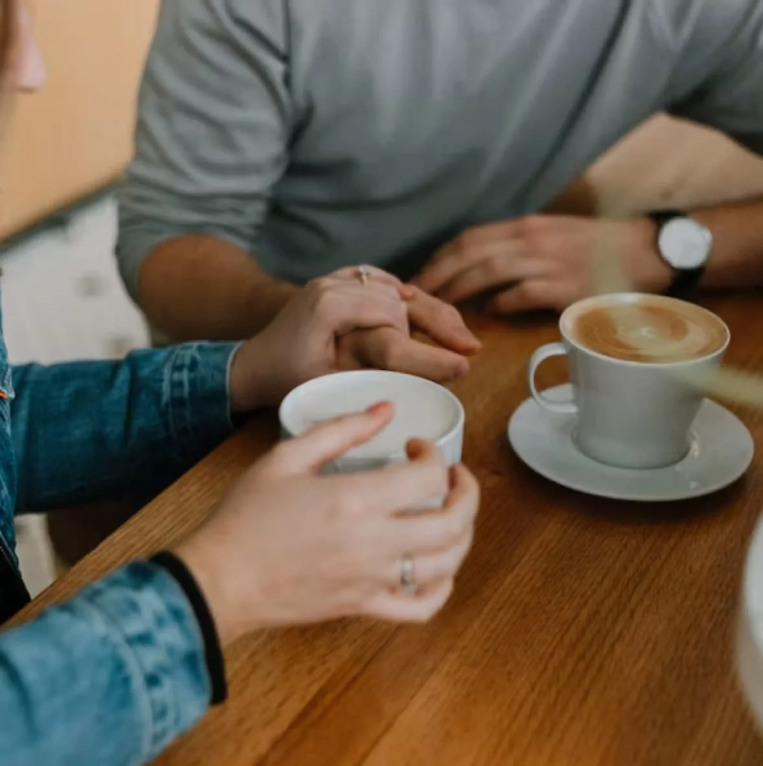 Two people having a supportive conversation over coffee