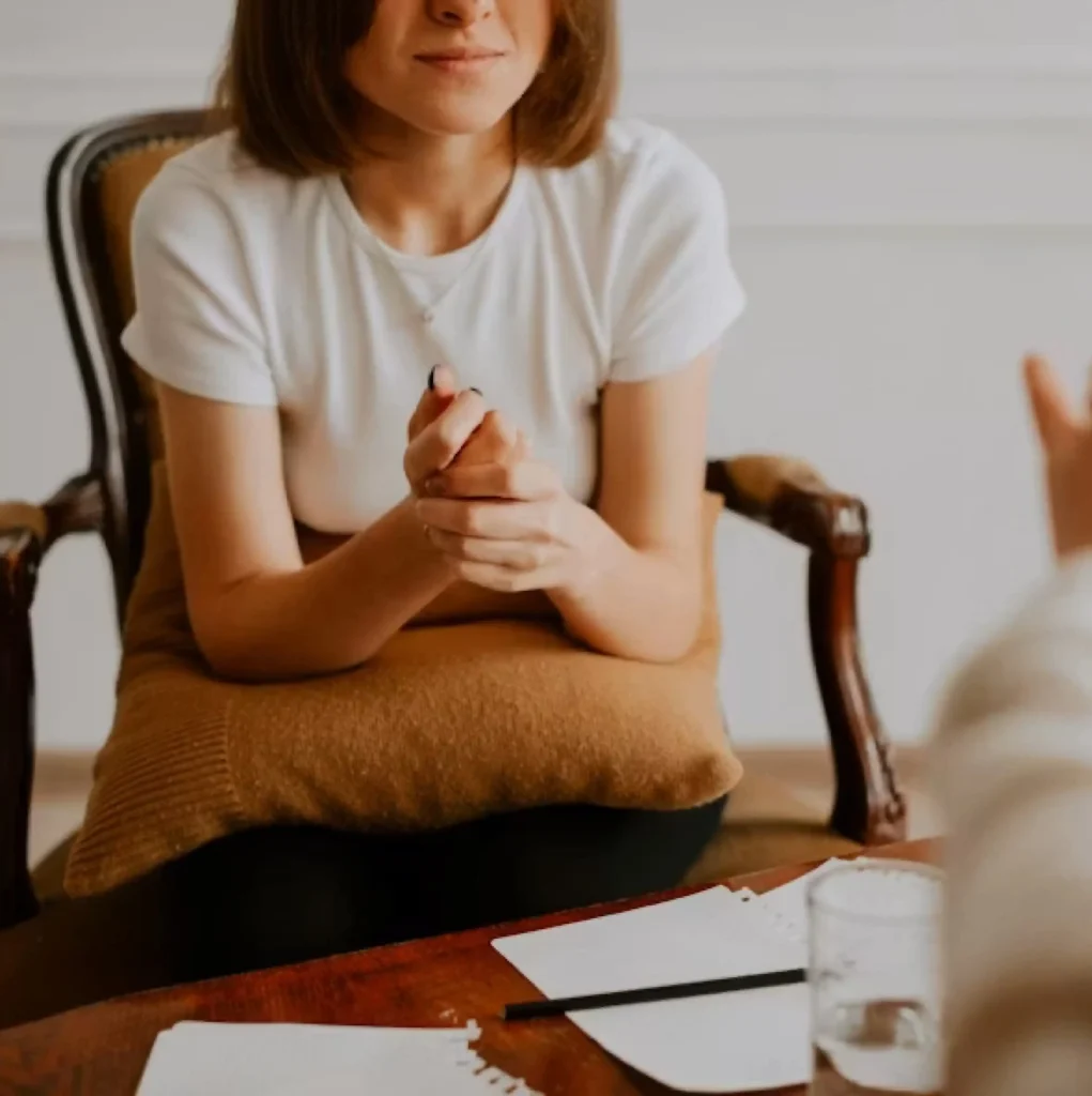 Woman speaking with a therapist during a private therapy session