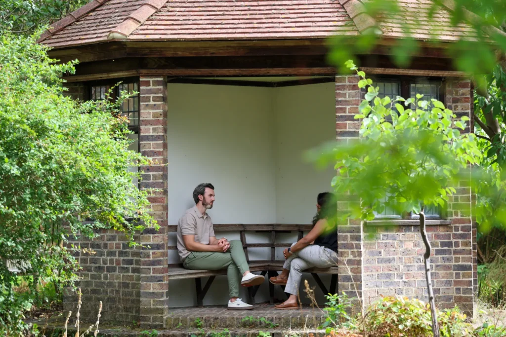 Ryan Hegarty speaking with a client during an outdoor therapy session
