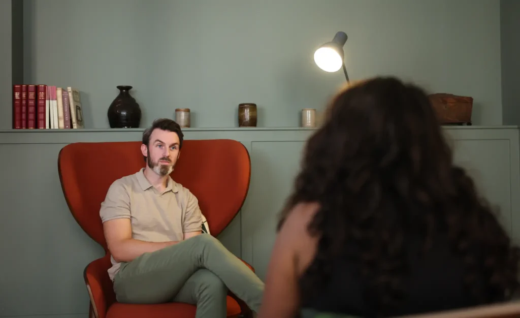 Ryan Hegarty listening to a client during a private therapy session for professionals